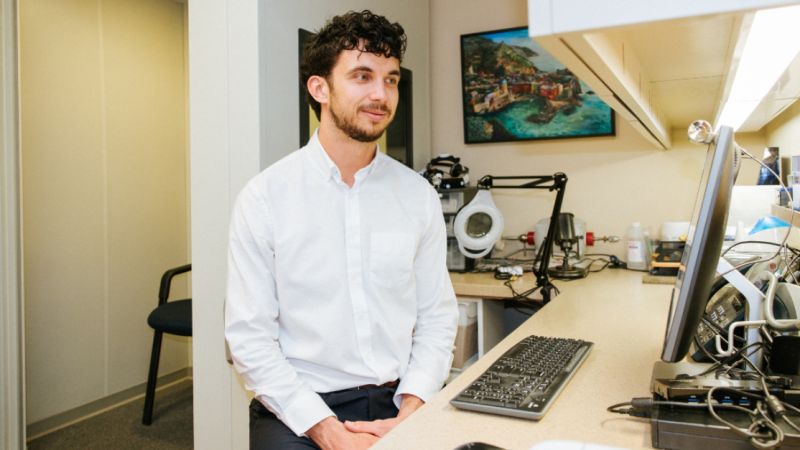 Ben working at his desk in the clinic office