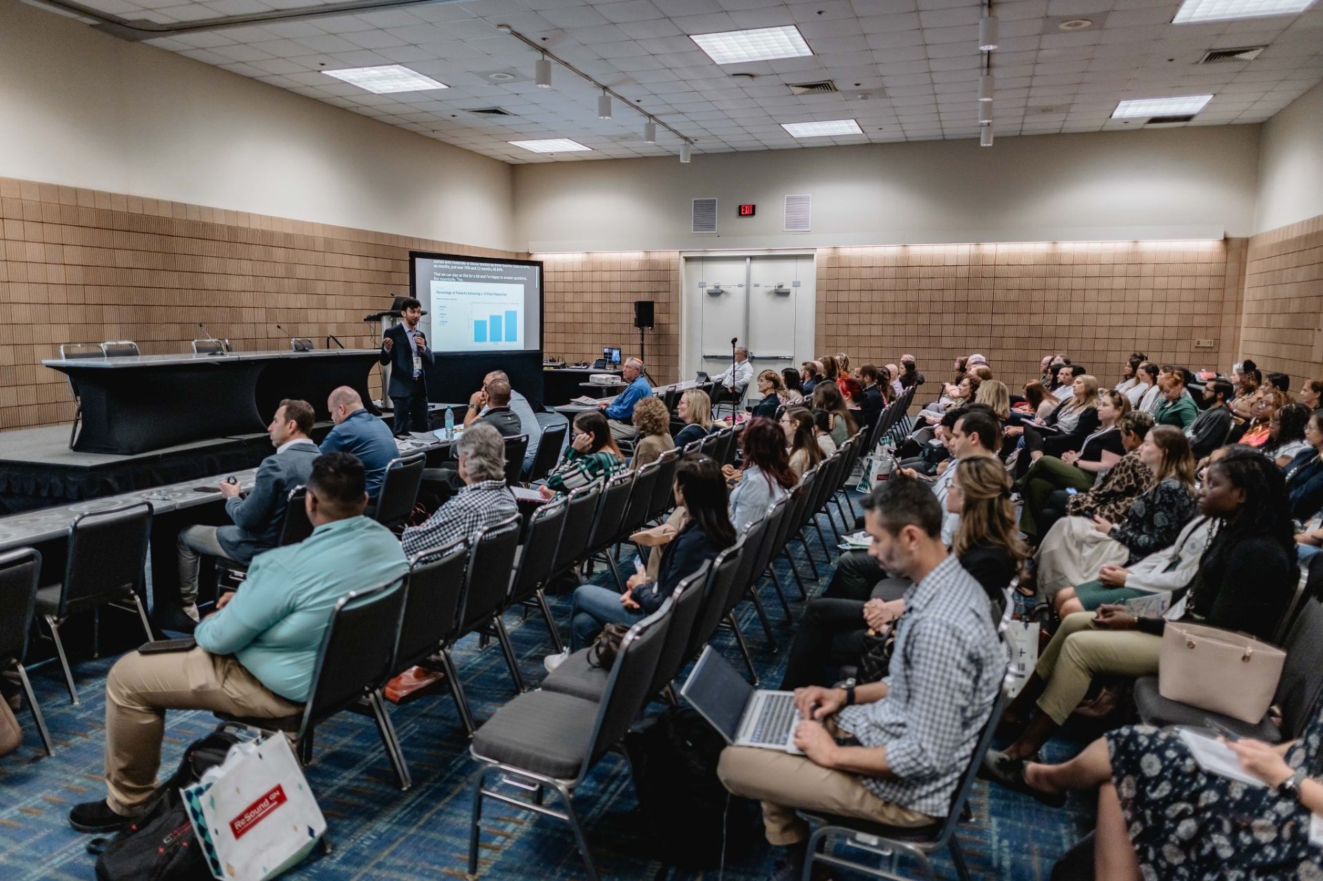 Ben presenting to a large conference audience